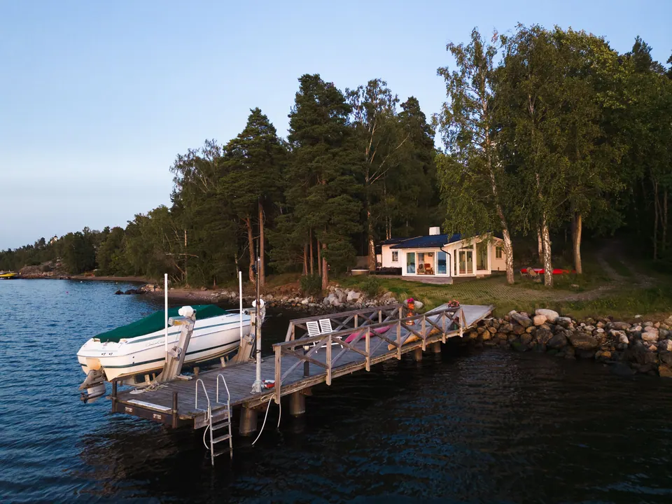 Seaside Cottage beyond the dock and calm water
