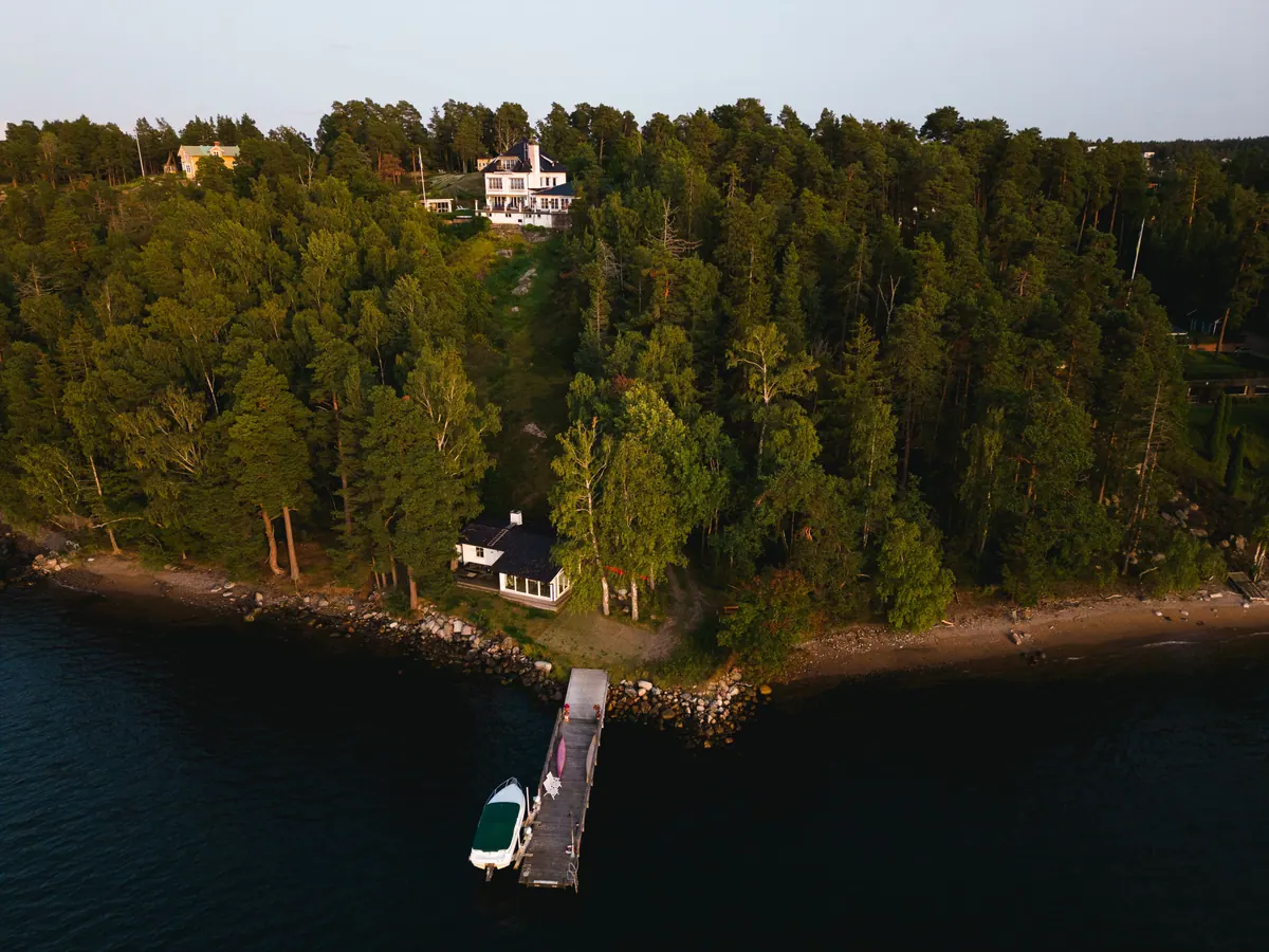 Aerial view of the private jetty, boat and shoreline.